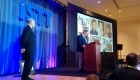 Trenchless Technology publisher Bernie Krzys looks on as jIm Rankin accepts his award.