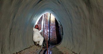 Spray-Applied Lining Systems Address Unique Infrastructure Problems worker surveying base of brick manhole