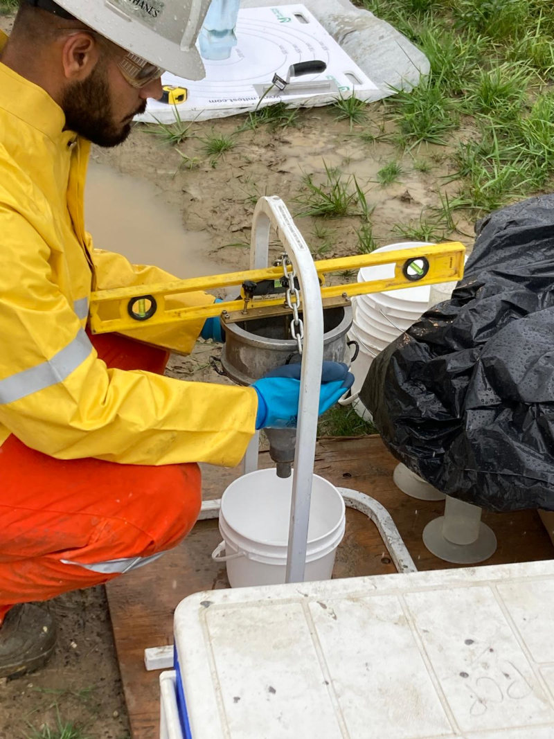 Yash Thapar, grouting specialist, calibrates the ﬂow cone test in preparation for on-site testing for thermal grout before and during pumping. The ﬂow cone and slump ﬂow tests complete the pumpability of materials delivered to the site. 